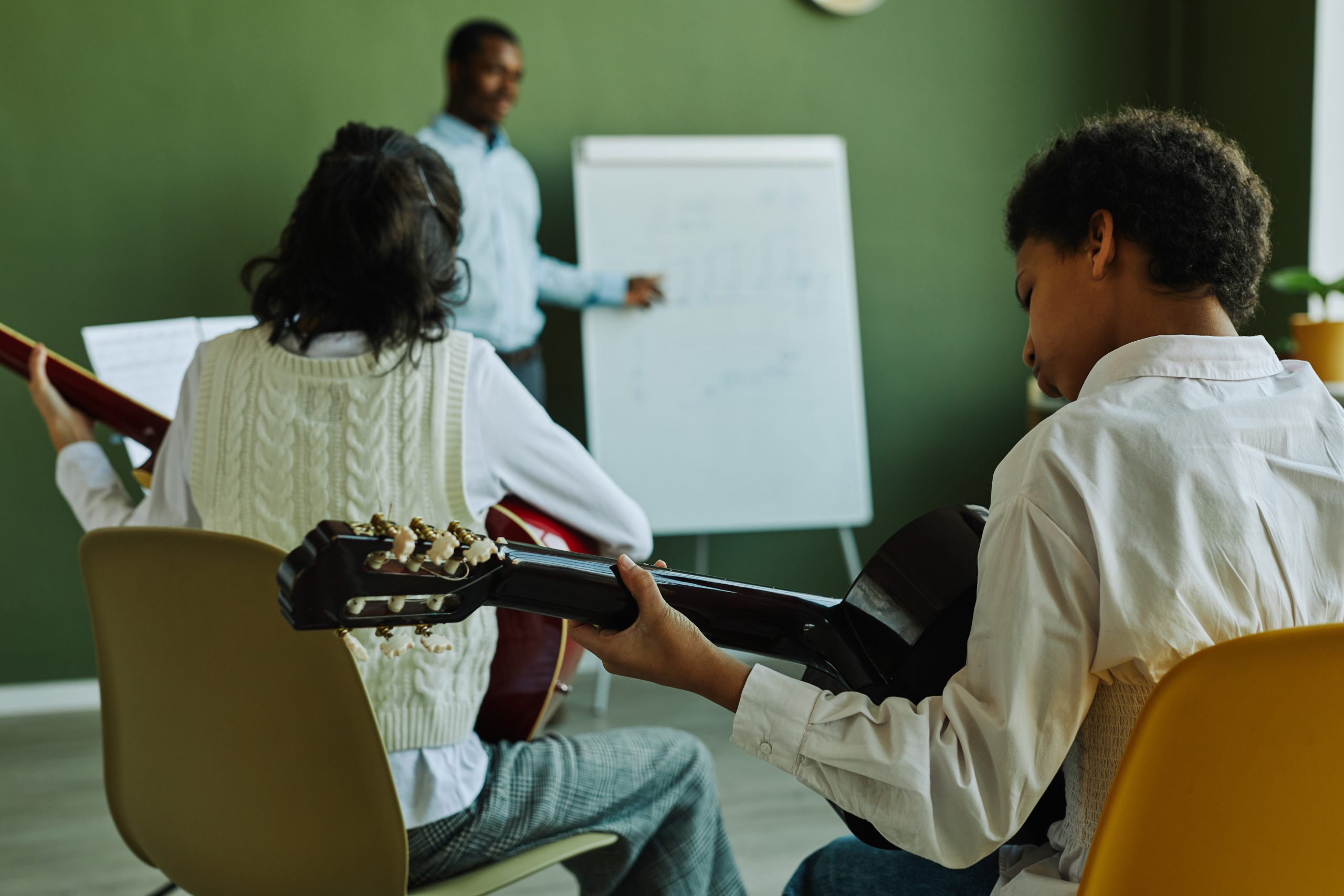 children holding guitar