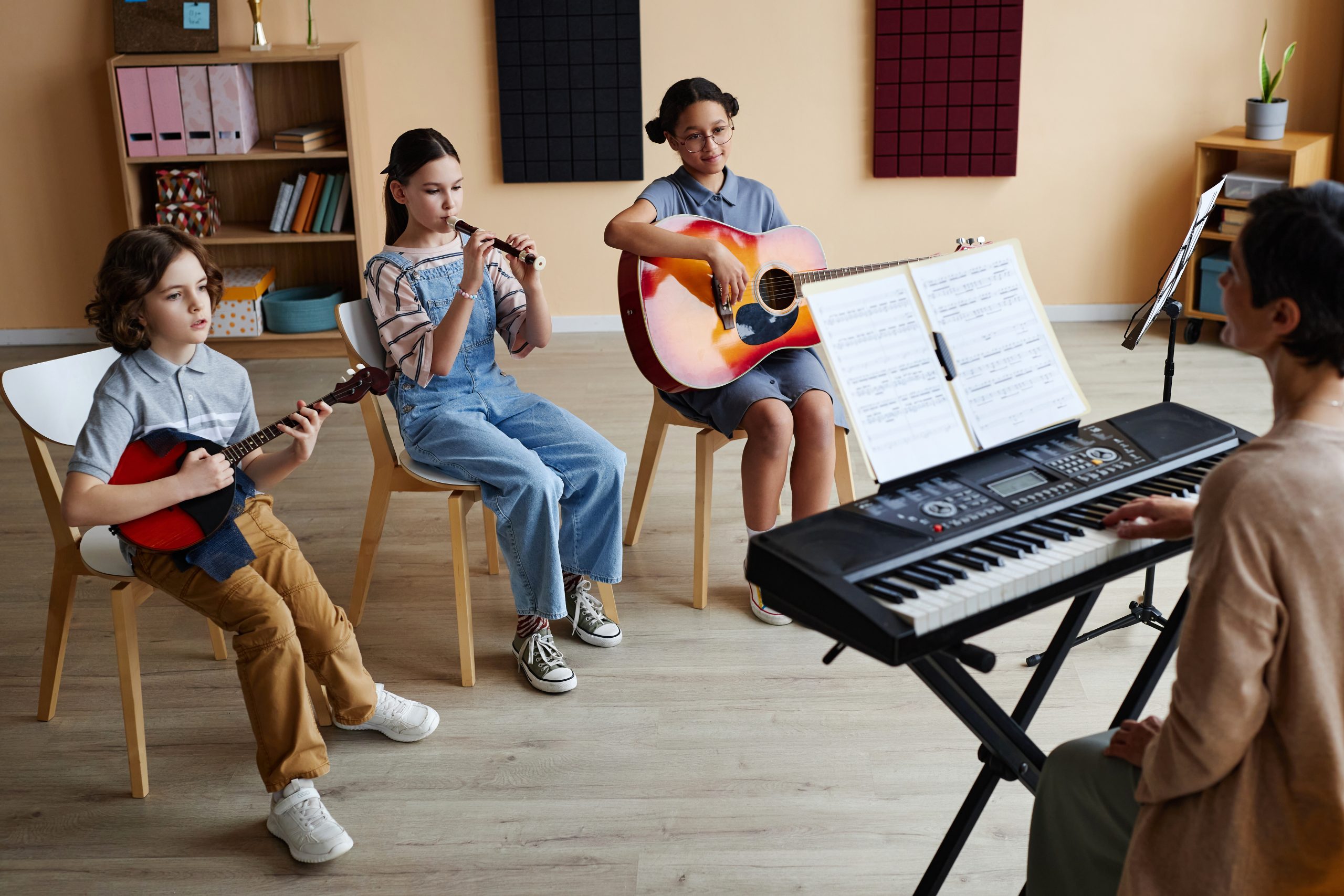 children playing instrument with there teacher