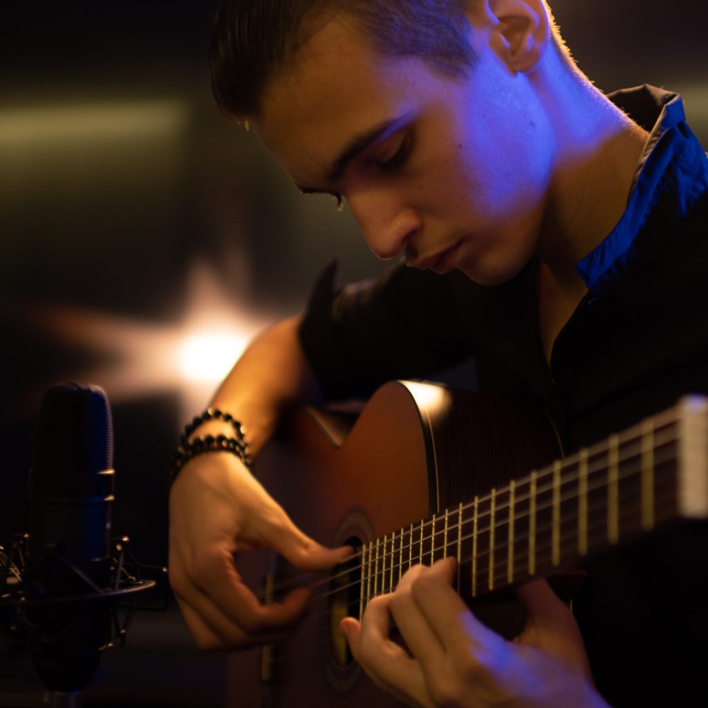 a young man playing guitar