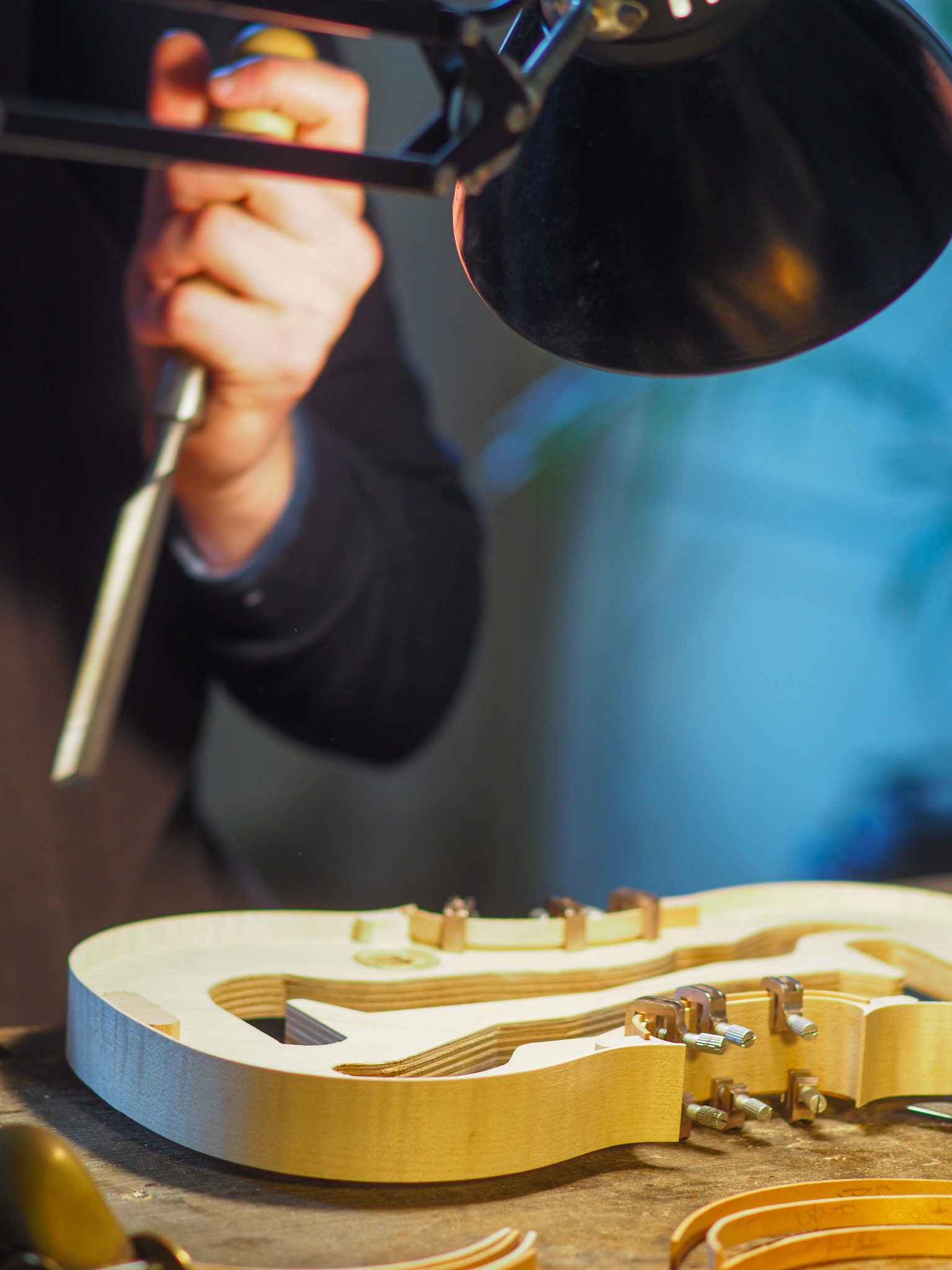 a person working on a guitar