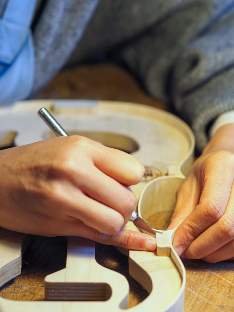 a person working on a guitar