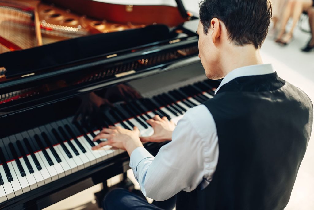 pianist playing on a grand piano