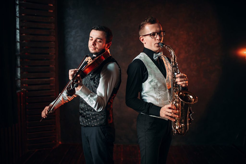 musicians playing violin and saxophone